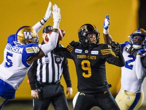 Tiger-Cats quarterback Dane Evans (9) throws ball under pressure in the second half against the Winnipeg Blue Bombers during the 107th Grey Cup championship football game at McMahon Stadium. Mandatory Credit: Sergei Belski-USA TODAY Sports