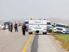 RCMP officers on scene on Highway 11 after the arrest of mass-stabbing suspect Myles Sanderson, north of Saskatoon on September 7, 2022.