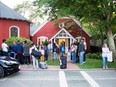 Venezuelan migrants stand outside St. Andrew's Church in Edgartown, Mass., Sept. 14, 2022.