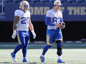 Injured wide receiver Drew Wolitarsky (right) walks with Brady Oliveira during Winnipeg Blue Bombers practice on Tuesday, Sept. 13, 2022.