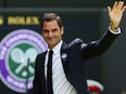 Swiss tennis player Roger Federer waves during the Centre Court Centenary Ceremony, on the seventh day of the 2022 Wimbledon Championships at The All England Tennis Club in Wimbledon, southwest London, on July 3, 2022.