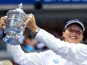 Poland's Iga Swiatek celebrates with the trophy after winning against Tunisia's Ons Jabeur during their 2022 US Open Tennis tournament women's singles final match at the USTA Billie Jean King National Tennis Center in New York, on September 10, 2022.