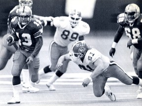 Winnipeg Blue Bomber quarterback Tom Burgess scrambles with the ball in the first quarter of the Grey Cup against the Edmonton Eskimos. The Bombers went on to beat the Eskimos 50-11 in Vancouver on Nov. 26, 1990. Edmonton Journal File photo