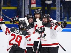 Canada players celebrate after Brianne Jenner (second right) scored her second goal of the game during the IIHF World Championship Woman's ice hockey gold medal match between USA and Canada in Herning, Denmark, Sunday, Sept. 4, 2022.