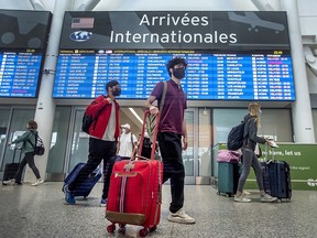 Travellers arrive at Toronto Pearson International Airport’s Terminal 1 as delays continue, Thursday July 7, 2022.