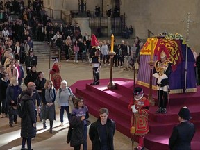 Members of the public view the coffin of Queen Elizabeth II, lying in state on the catafalque in Westminster Hall, at the Palace of Westminster, London, ahead of her funeral on Monday, on Sept. 14, 2022 in London.
