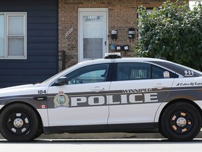 A police cruiser sits in front of a duplex on Logan Avenue near McPhillips Street in Winnipeg on Monday, Sept. 5, 2022. A person there was shot in the leg during a home invasion at about 2 a.m., police say.