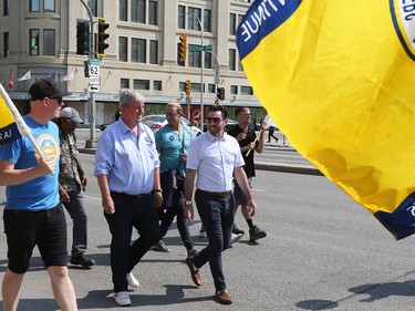 Mayoral hopeful Glen Murray (centre) takes part in the Labour Day March in Winnipeg on Monday, Sept. 5, 2022.