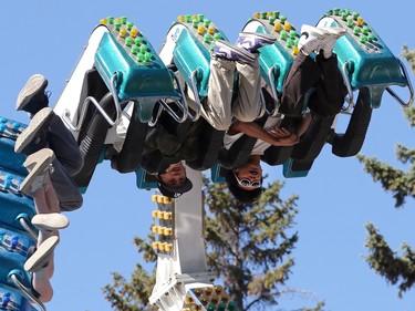 Riders go upside down on a midway ride at ManyFest street festival in downtown Winnipeg on Sunday, Sept. 11, 2022, which returned after a two-year absence due to COVID-19.