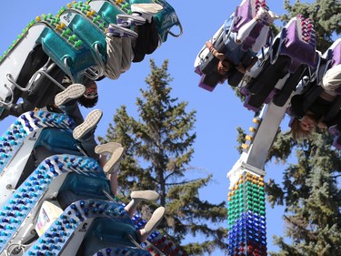Riders go upside down on a midway ride at ManyFest street festival in downtown Winnipeg on Sunday, Sept. 11, 2022. The street festival returned after a two-year absence due to COVID-19.