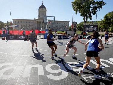 A 3-on-3 basketball tournament game is played in front of the Manitoba Legislative Building during ManyFest in downtown Winnipeg on Sunday, Sept. 11, 2022. The street festival returned after a two-year absence due to COVID-19.