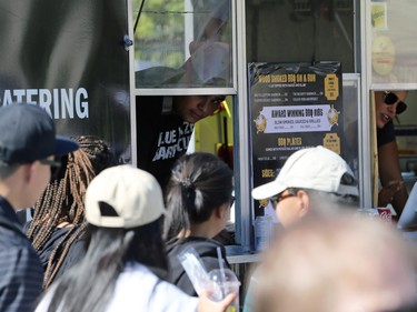 A food truck employee checks out the long lineup during the Food Truck Wars at ManyFest in downtown Winnipeg on Sunday, Sept. 11, 2022. The street festival returned after a two-year absence due to COVID-19.