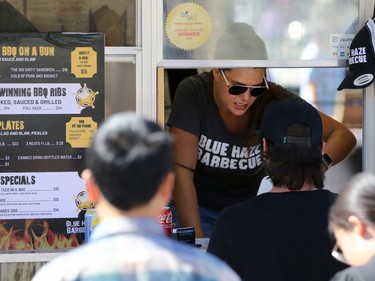 A food truck employee takes orders during the Food Truck Wars at ManyFest in downtown Winnipeg on Sunday, Sept. 11, 2022. The street festival returned after a two-year absence due to COVID-19.