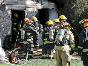 Firefighters gathered at a house on Union Avenue West in Winnipeg on Sunday, Sept. 25, 2022. A fire broke out at the home at about 8 a.m., with firefighters returning at about 11:30 a.m. after it reignited.