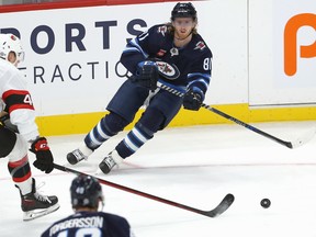 Winnipeg Jets forward Kyle Connor (right) feeds a pass to Daniel Torgersson for a goal against the Ottawa Senators in NHL exhibition action at Canada Life Centre on Tuesday, Sept. 27, 2022.