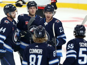 Winnipeg Jets forward Mikey Eyssimont (top right) celebrates his power-play goal against the Ottawa Senators with Josh Morrissey, Nikolaj Ehlers, Kyle Connor and Mark Scheifele (from left) during NHL exhibition action at Canada Life Centre on Tue., Sept. 27, 2022. KEVIN KING/Winnipeg Sun/Postmedia Network