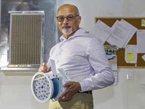 Nexnord CEO Shan Jamal holds a UVC lighting unit used in duct work that the company says is capable of eradicating the COVID-19 virus. Brian Thompson/Postmedia Network