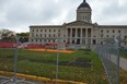 A chain-link fence now surrounds the area where an encampment on the north side of the Manitoba Legislative Building stood, after police moved in and forced people out of the encampment this week.