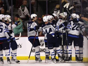 TEMPE, ARIZONA - OCTOBER 28: The Winnipeg Jets celebrate after Blake Wheeler #26 scored the game-wining goal during overtime of NHL game against the Arizona Coyotes at Mullett Arena on October 28, 2022 in Tempe, Arizona. The Jets defeated the Coyotes 3-2 in overtime.  (Photo by Christian Petersen/Getty Images)