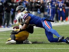 Damar Hamlin of the Buffalo Bills tackles Kenny Pickett of the Pittsburgh Steelers.