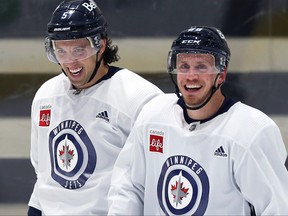 Veteran defencemen Brenden Dillon (left) and Nate Schmidt share a laugh during Winnipeg Jets training camp.