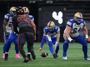 Winnipeg Blue Bombers quarterback Dru Brown drops the ball before throwing an interception during the first half of a CFL football game against the B.C. Lions in Vancouver, on Saturday, October 15, 2022.