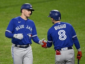 Blue Jays' Matt Chapman, left, celebrates with Cavan Biggio after scoring in the second inning against the Orioles at Oriole Park at Camden Yards in Baltimore, Monday, Oct. 3, 2022.
