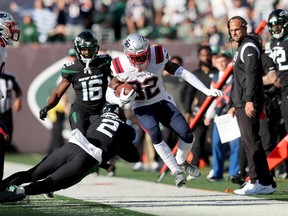 New England Patriots safety Devin McCourty (32) is forced out of bounds by New York Jets quarterback Zach Wilson (2) after an interception during the fourth quarter at MetLife Stadium.