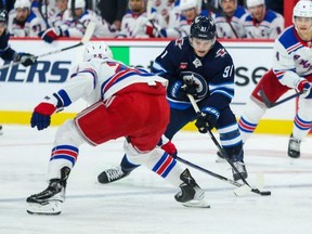 Winnipeg Jets forward Cole Perfetti  skates in on New York Rangers defenceman Libor Hajek during the second period at Canada Life Centre Friday night. Terrence Lee/USA TODAY Sports