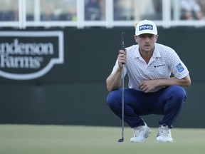 Canadian Mackenzie Hughes reacts after putting in to win on the second playoff hole against Sepp Straka of Austria on the 18th green during the final round of the Sanderson Farms Championship at The Country Club of Jackson in Jackson, Miss., yesterday.  Raj Mehta/Getty Images