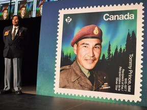Tommy Prince Jr., left, the son of the late Sgt. Tommy Prince helped to unveil a new Canada Post stamp on Monday that pays tribute to his late father. Dave Baxter/Winnipeg Sun/Local Journalism Initiative