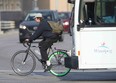 A cyclist and a transit bus in a diamond lane in Winnipeg on Wednesday, Oct. 5.