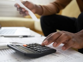 Close up of a man with calculator checking bills