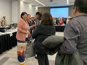 Newly elected Grand Chief Cathy Merrick, second left, of the Assembly of Manitoba Chiefs greets people shortly after First Nations chiefs in the province voted her as the next leader of the advocacy organization in Winnipeg on Wednesday, Oct. 26, 2022. Chiefs in Manitoba have elected the first female leader of one of the largest First Nations advocacy groups in the province.