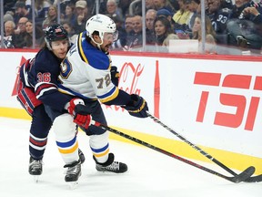 St. Louis Blues defenceman Justin Faulk (72) battles Winnipeg Jets forward Morgan Barron (36) for the puck during the second period at Canada Life Centre on Oct 24, 2022. Terrence Lee-USA TODAY Sports