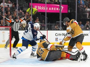 Oct 20, 2022; Las Vegas, Nevada, USA; Vegas Golden Knights goaltender Adin Hill (33) makes a save as Winnipeg Jets defenseman Dylan DeMelo (2) and Vegas Golden Knights defenseman Zach Whitecloud (2) look for the rebound during the first period at T-Mobile Arena. Mandatory Credit: Stephen R. Sylvanie-USA TODAY Sports