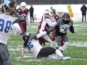 Thunder running back Ryland Leichert — who racked up 390 yards rushing in the game — is corralled by a couple of Winnipeg defenders during yesterday’s junior semifinal in Regina.