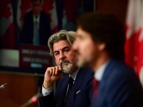 Leader of the Government in the House of Commons Pablo Rodriguez looks towards Prime Minister Justin Trudeau as they take part in a press conference in Ottawa on Friday, Oct. 16, 2020.