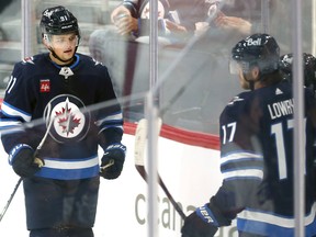 Winnipeg Jets forward Cole Perfetti (left) heads over to congratulate Ville Heinola on his power-play goal against the Ottawa Senators in NHL exhibition action at Canada Life Centre on Tuesday, Sept. 27, 2022.