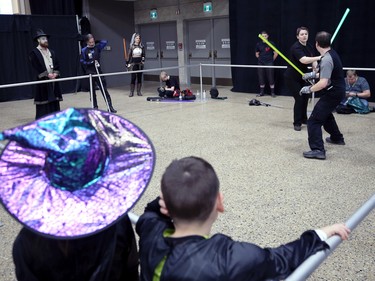 Children in costume watch a lightsabre duel between River City Jedi members during Winnipeg Comiccon at the RBC Convention Centre on Sunday, Oct. 30, 2022.