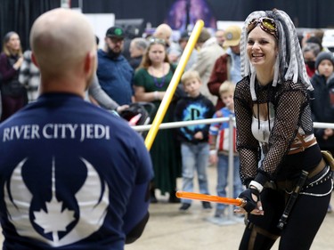 Shandell Kenny from River City Jedi laughs with her opponent in a lightsabre duel during Winnipeg Comiccon at the RBC Convention Centre on Sunday, Oct. 30, 2022.