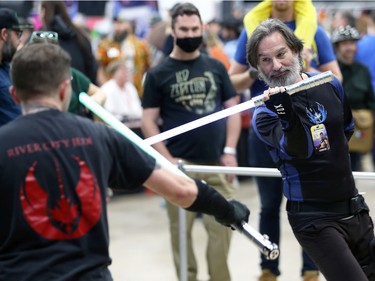 A jedi who has lost an arm during battle soldiers on during a lightsaber duel at Winnipeg Comiccon at the RBC Convention Centre on Sunday, Oct. 30, 2022.
