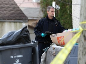 A forensics officers from the Winnipeg Police Service investigates in the backyard of a residence in the 100 block of Johnson Avenue West in Winnipeg on Mon., Oct. 31, 2022. Police found an unresponsive male near a residence at about 2:29 a.m. and he was pronounced deceased at hospital. His death is being treated as a homicide. KEVIN KING/Winnipeg Sun