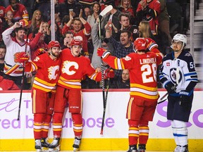Adam Ruzicka (63) of the Calgary Flames celebrates after scoring against the Winnipeg Jets during the first period of an NHL game at Scotiabank Saddledome on Nov. 12, 2022 in Calgary.