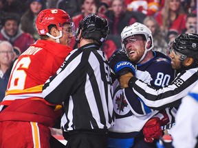Nikita Zadorov (16) of the Calgary Flames mixes it up with Pierre-Luc Dubois (80) of the Winnipeg Jets during the second period of an NHL game at Scotiabank Saddledome on Nov. 12, 2022 in Calgary.