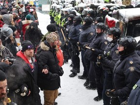 Police face off with demonstrators in downtown Ottawa on Feb. 19, 2022 .