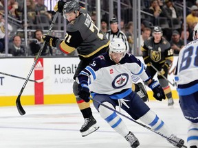 William Karlsson #71 of the Vegas Golden Knights tries to get around Brenden Dillon #5 of the Winnipeg Jets in the second period of their game at T-Mobile Arena on October 30, 2022 in Las Vegas, Nevada. The Golden Knights defeated the Jets 2-1 in overtime. (Photo by Ethan Miller/Getty Images)