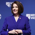 U.S. Sen. Catherine Cortez Masto (D-NV) listens as Nevada Gov. Steve Sisolak delivers remarks at an election night party hosted by Nevada Democratic Victory at The Encore on November 08, 2022 in Las Vegas, Nevada.