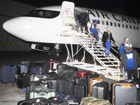 The Winnipeg Blue Bombers arrive at Kreos Aviation at the Regina Airport for the Grey Cup Championship on Tuesday.