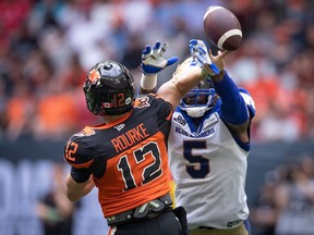 Winnipeg Blue Bombers' Willie Jefferson (5) blocks a pass attempt by B.C. Lions quarterback Nathan Rourke (12) during the first half of CFL football game at B.C. Place in July. The Bombers will be trying to turn the pressure up on Rourke when they meet in the West Final.